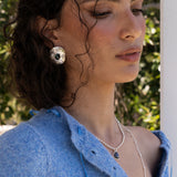 Darcy hammered oval stud earrings styled on model, Glass Blue Topaz and Freshwater Pearl in silver — Mountain & Moon jewellery