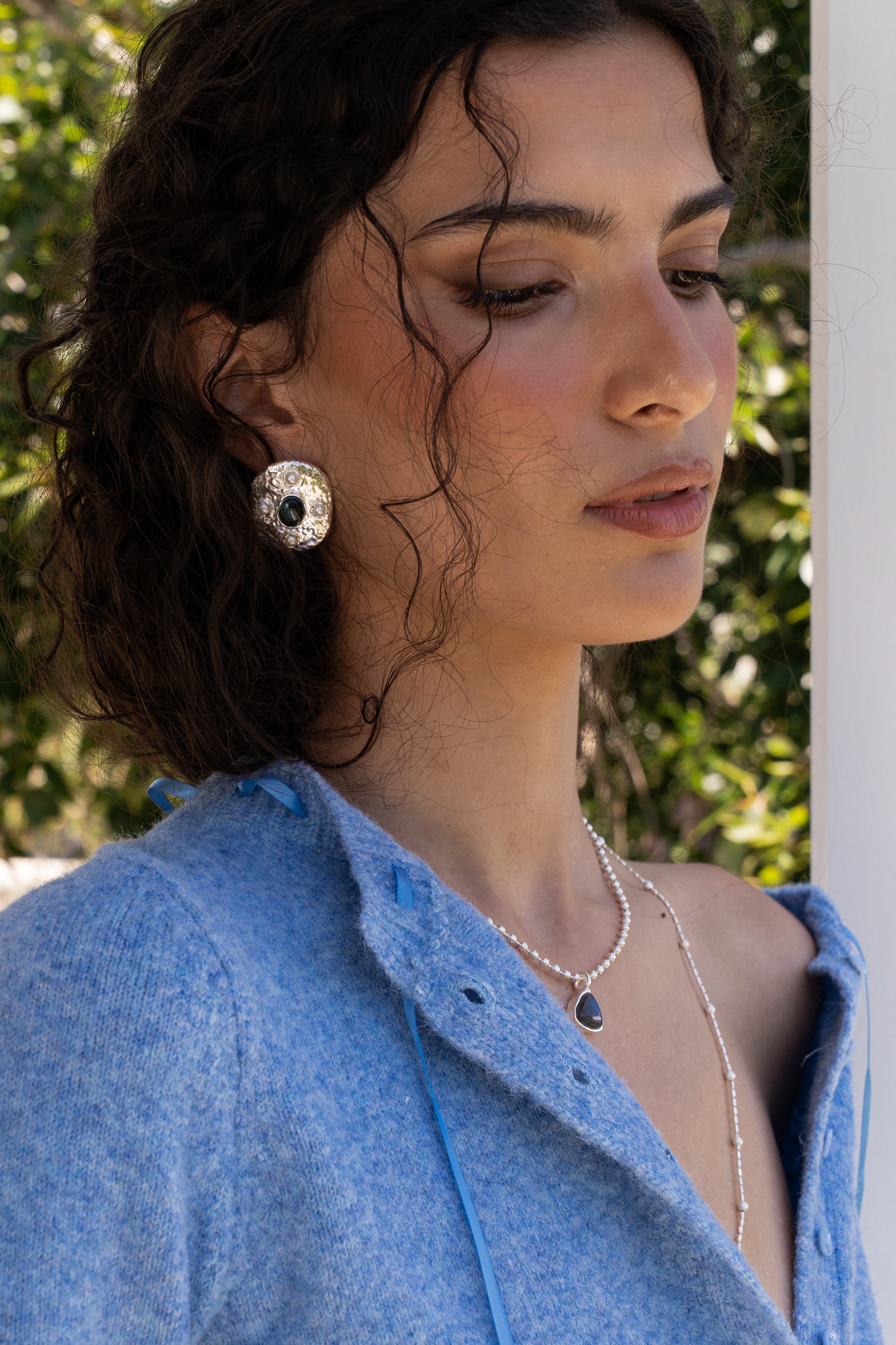 Darcy hammered oval stud earrings styled on model, Glass Blue Topaz and Freshwater Pearl in silver — Mountain & Moon jewellery