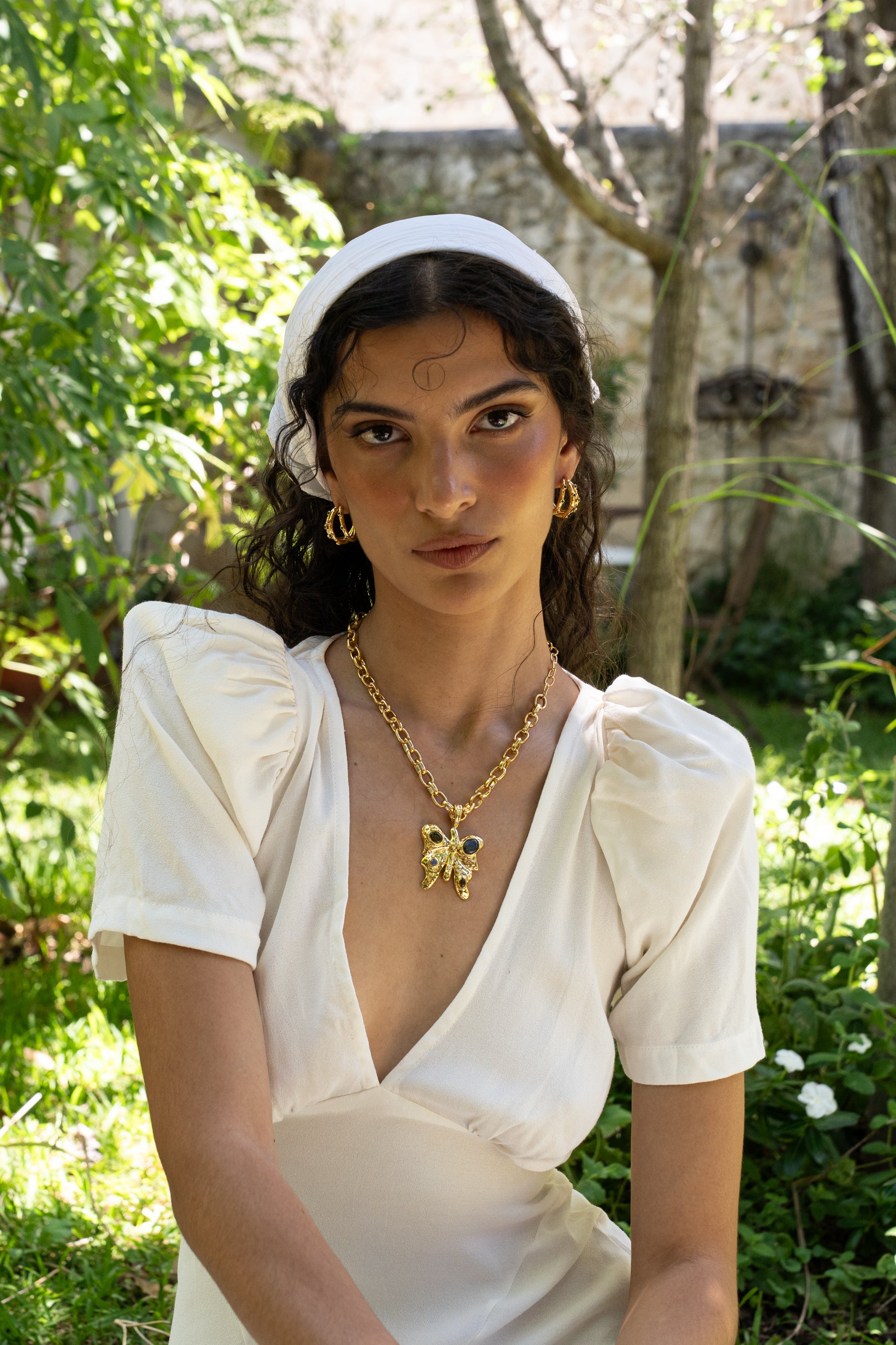 Alba gold ridged huggie hoop earrings with Green CZ worn by model — Mountain & Moon Chateau Soleil collection