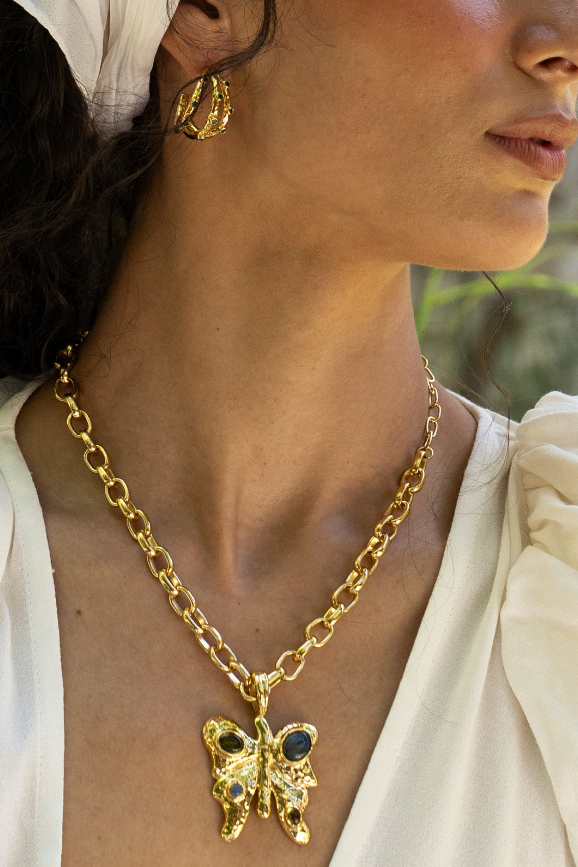 Rue gold butterfly pendant necklace with Glass Peridot and Labradorite worn by model — Mountain & Moon Chateau Soleil collection