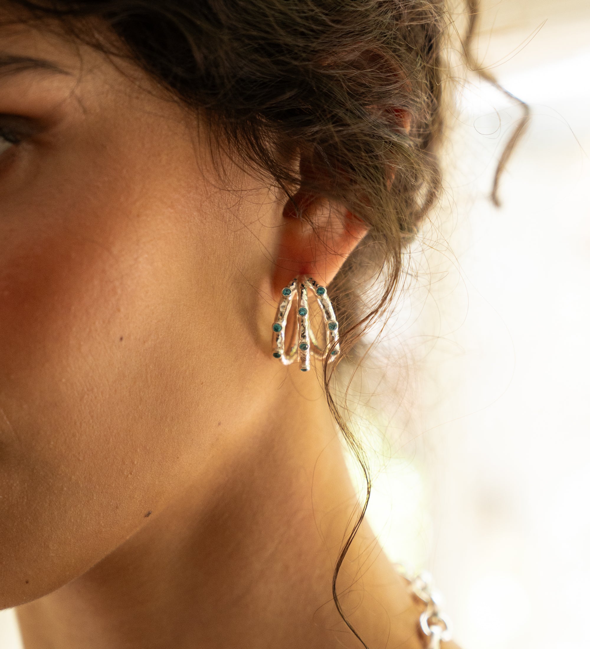 Alba silver ridged huggie hoop earrings with Blue CZ worn by model — Mountain & Moon Chateau Soleil collection