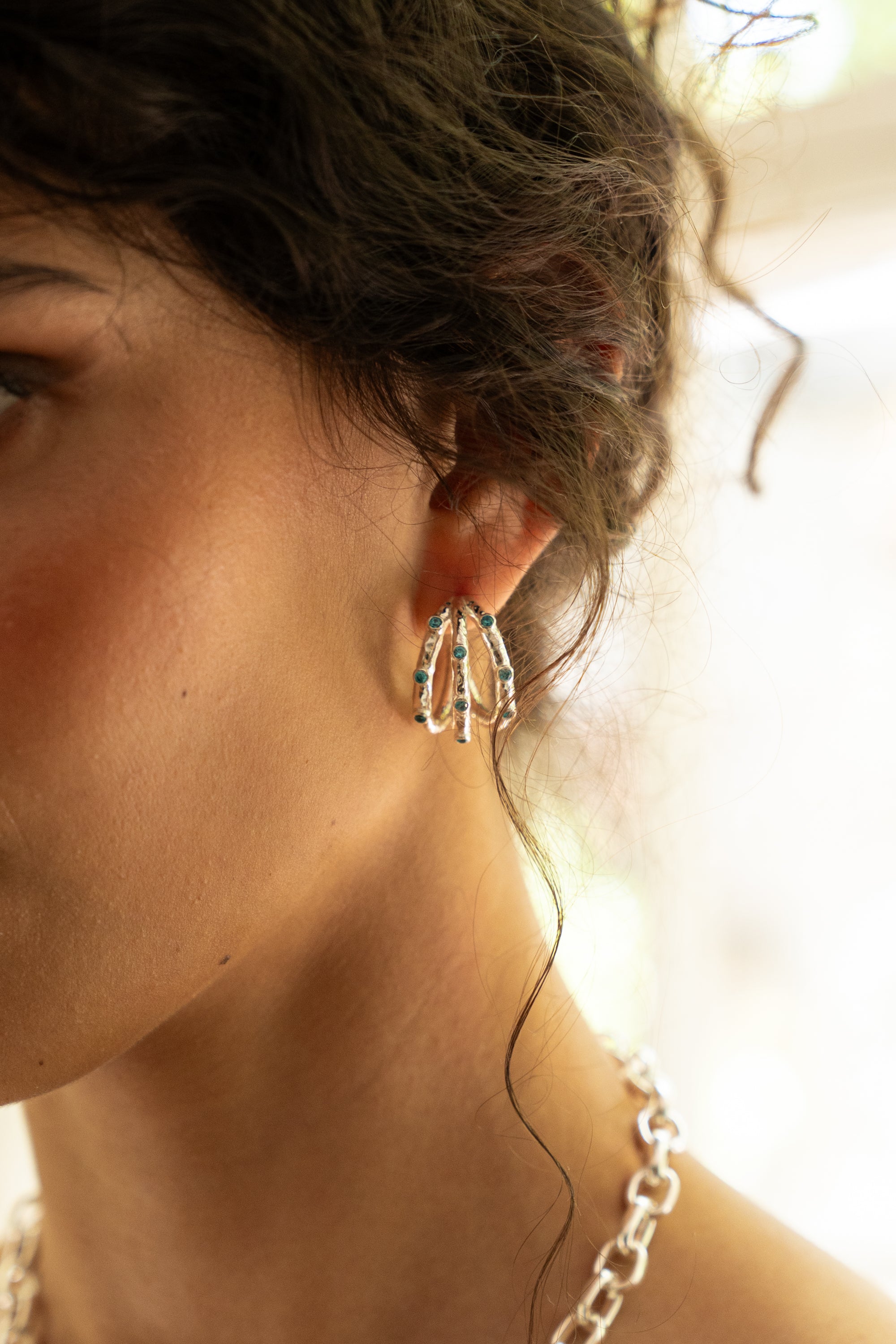 Alba silver ridged huggie hoop earrings with Blue CZ worn by model — Mountain & Moon Chateau Soleil collection