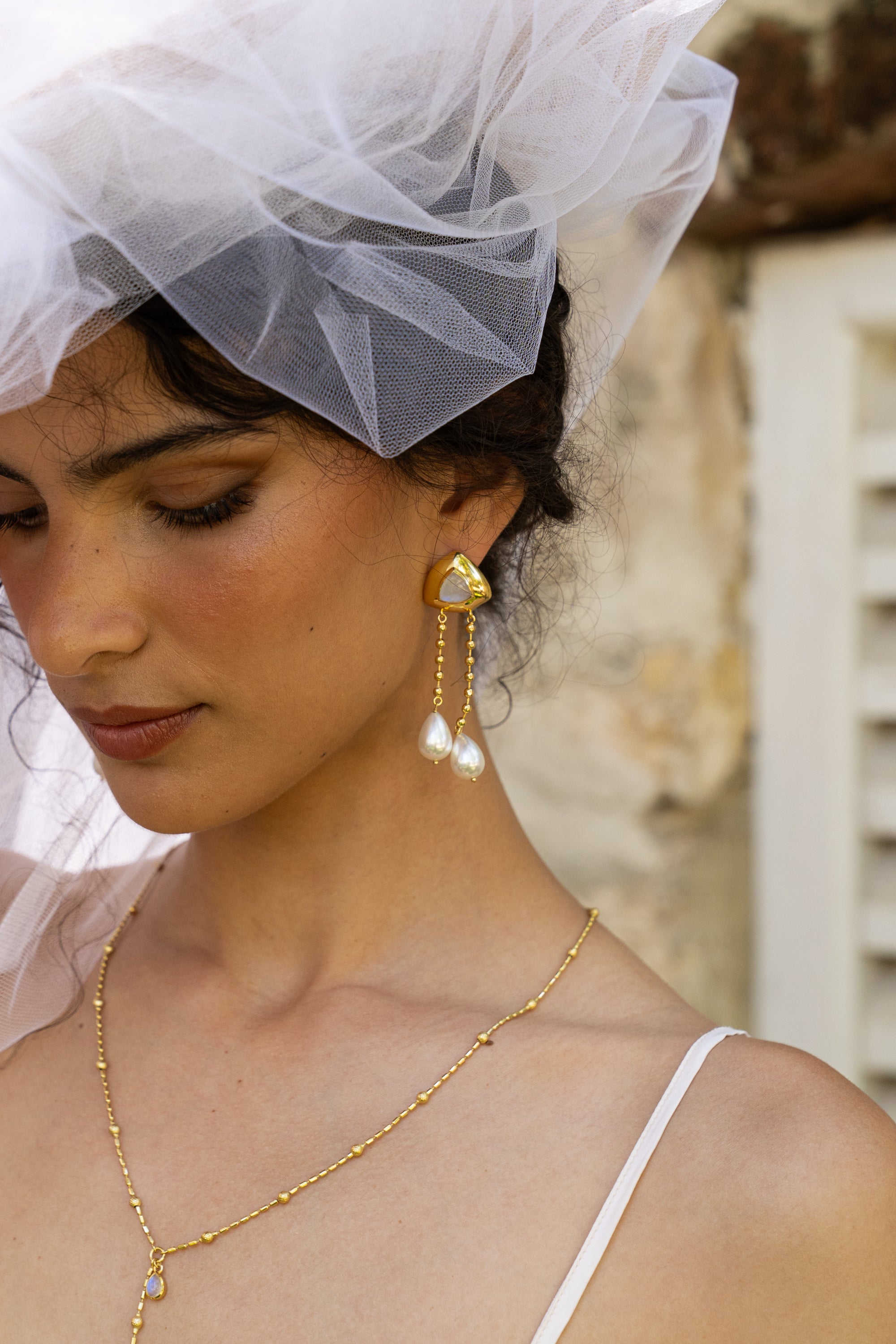 Liberty long dangle earrings styled on model, Rainbow Moonstone and Glass Pearl in gold — Mountain & Moon jewellery