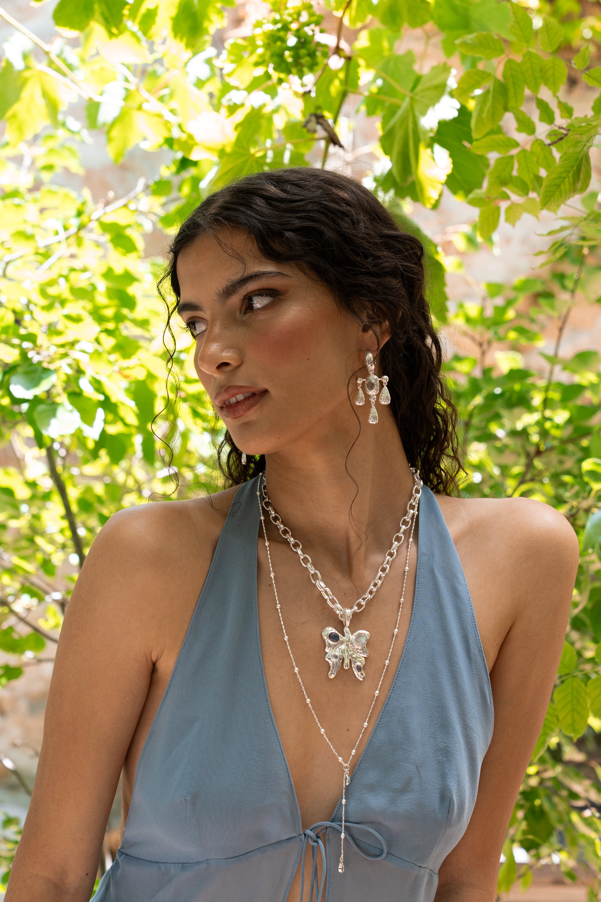 Rue silver butterfly pendant necklace with Rainbow Moonstone and Labradorite worn by model — Mountain & Moon Chateau Soleil collection