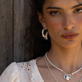 Artemis silver hammered huggie hoop earrings with Dalmatian Jasper worn by model — Mountain & Moon Chateau Soleil collection