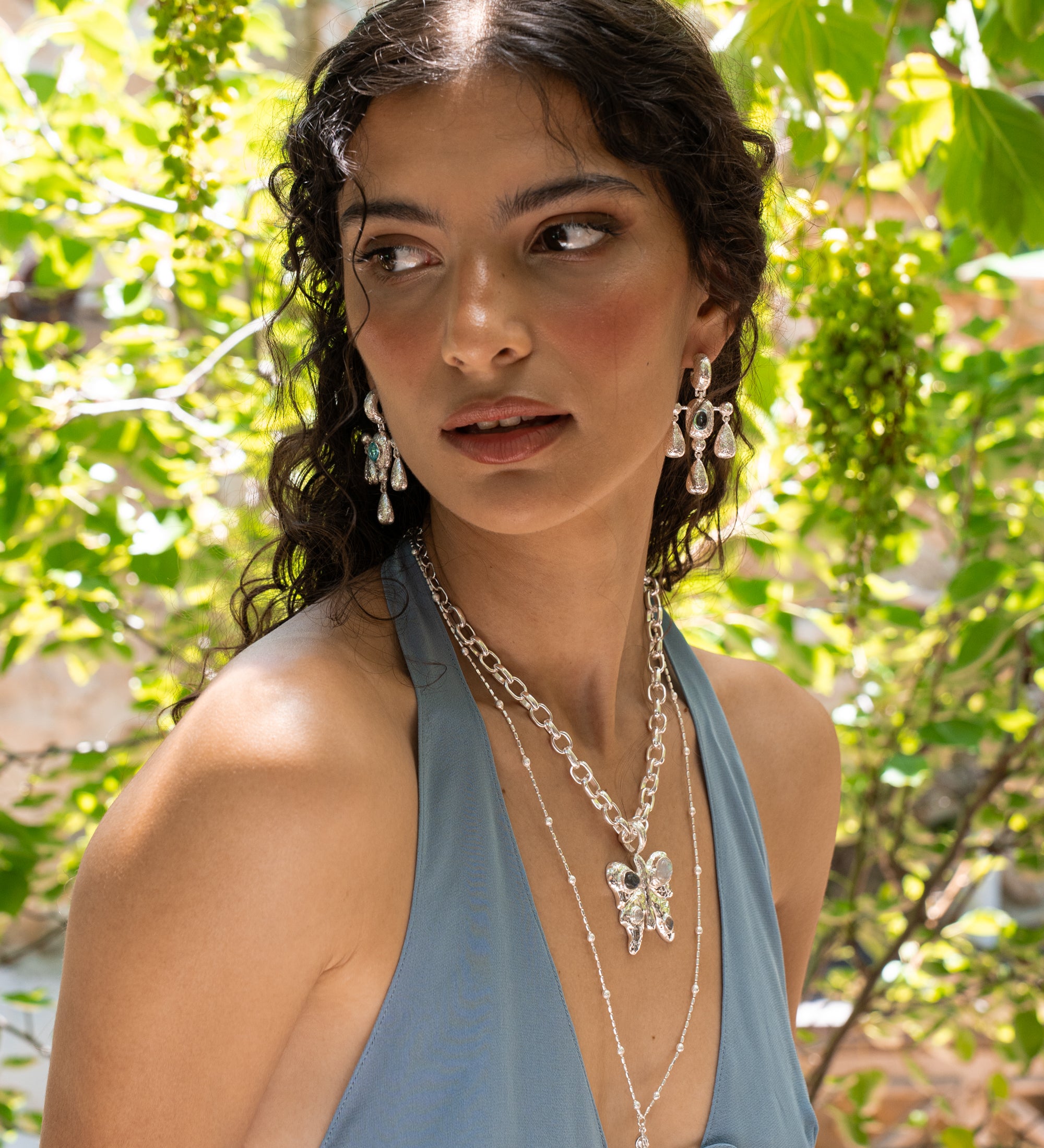 Fleur silver chandelier drop earrings with Glass Blue Topaz worn by model — Mountain & Moon Chateau Soleil collection