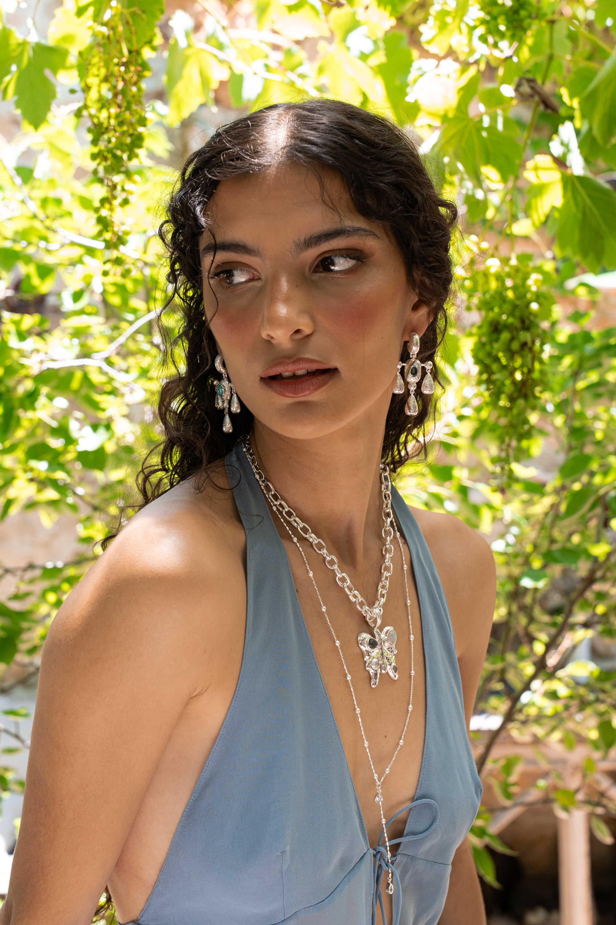 Fleur silver chandelier drop earrings with Glass Blue Topaz worn by model — Mountain & Moon Chateau Soleil collection