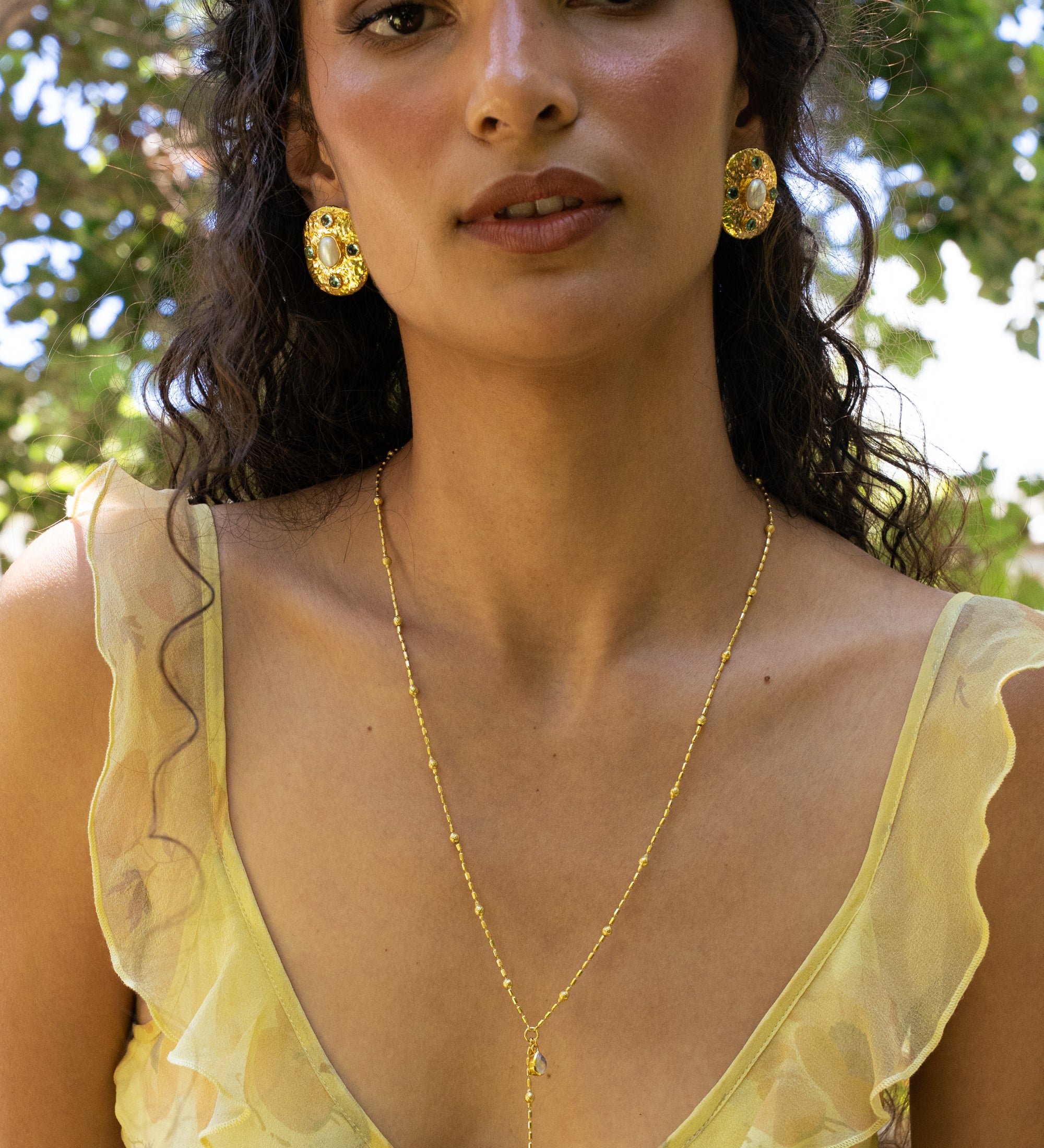 Darcy gold hammered oval stud earrings with Freshwater Pearl and Glass Blue Topaz worn by model — Mountain & Moon Chateau Soleil collection