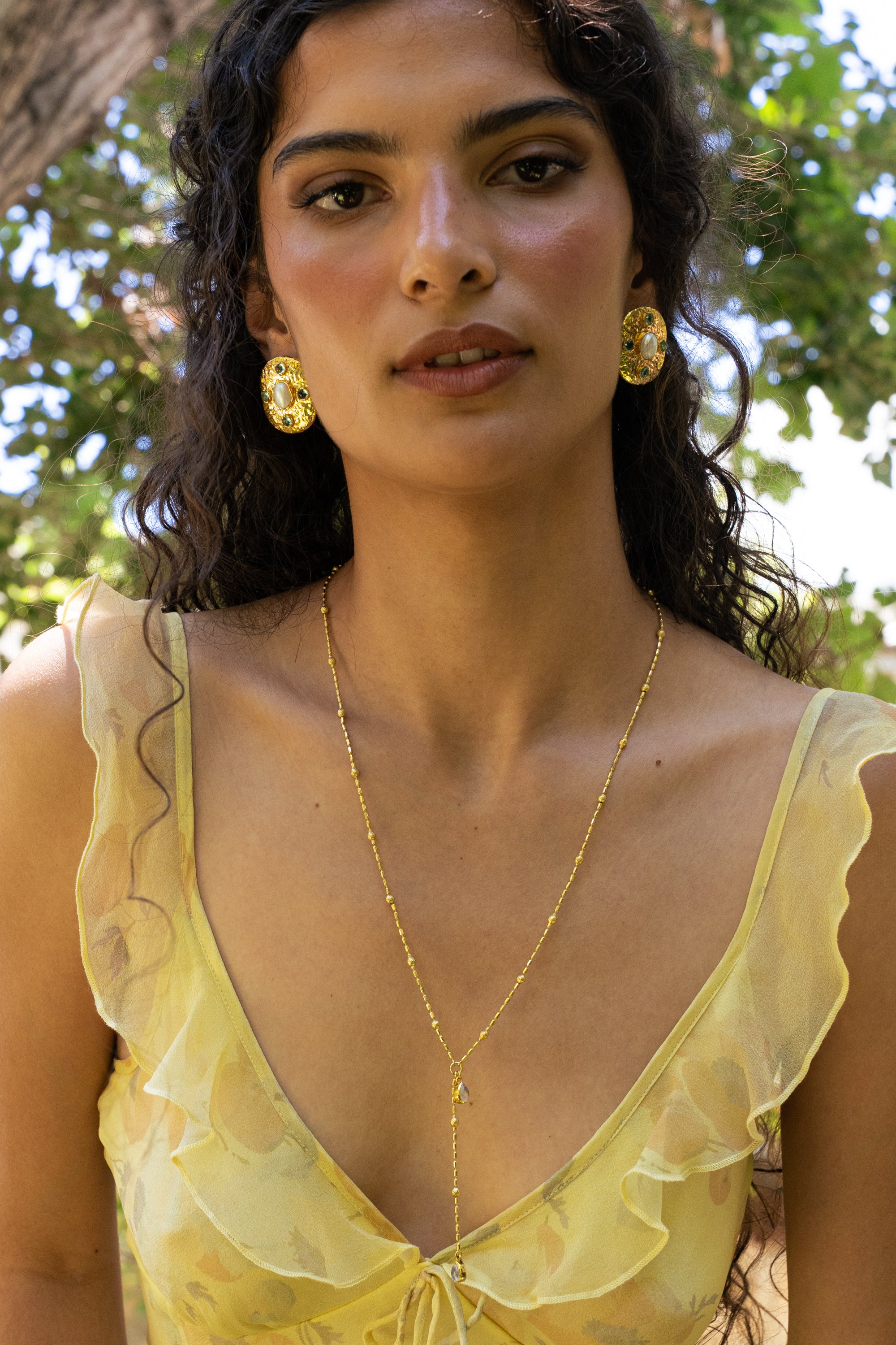 Darcy gold hammered oval stud earrings with Freshwater Pearl and Glass Blue Topaz worn by model — Mountain & Moon Chateau Soleil collection