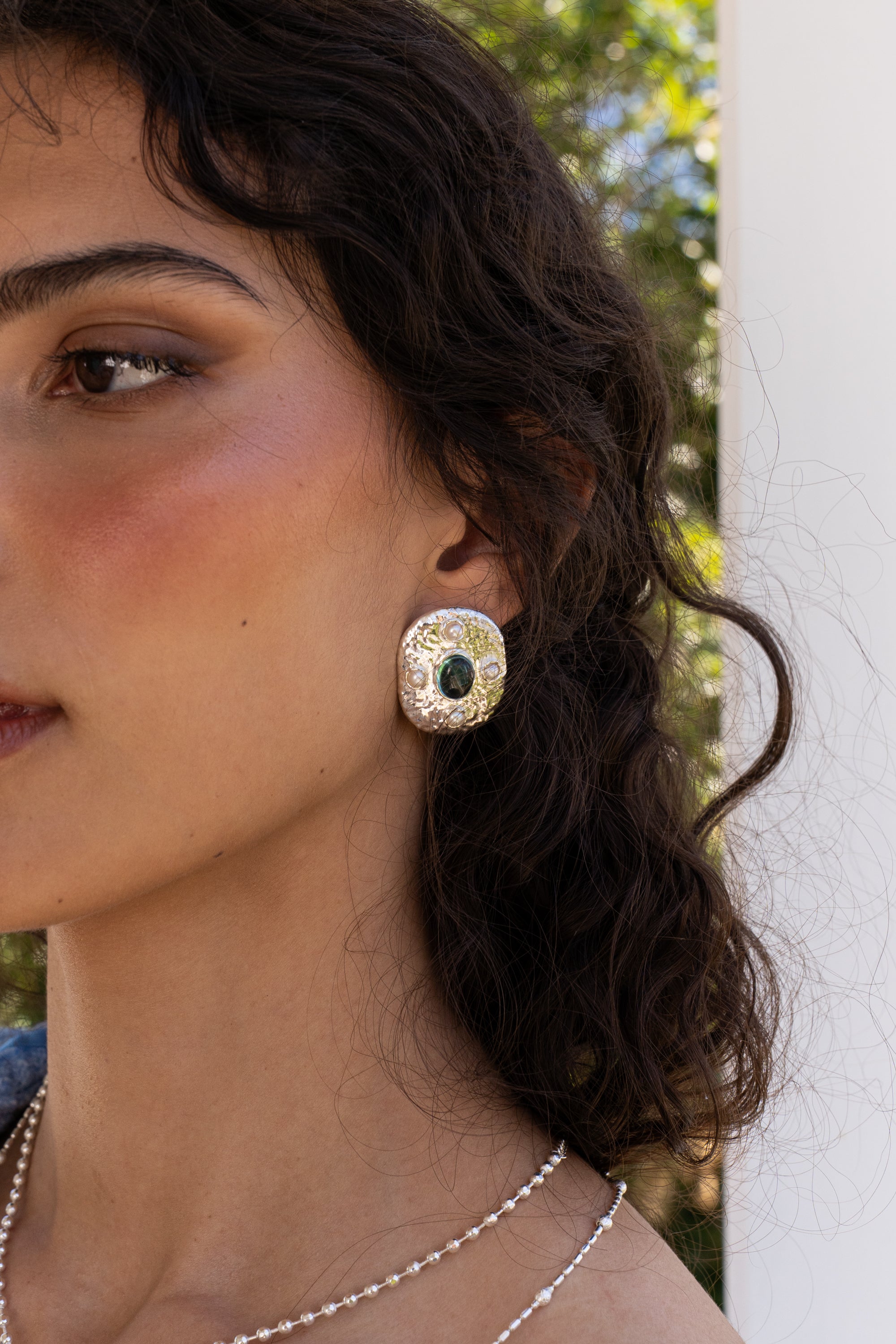 Darcy silver hammered oval stud earrings with Glass Blue Topaz and Freshwater Pearl worn by model — Mountain & Moon Chateau Soleil collection