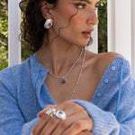 Glass Blue Topaz and Freshwater Pearl silver hammered oval stud earrings from the Chateau Soleil collection by Mountain & Moon — Darcy