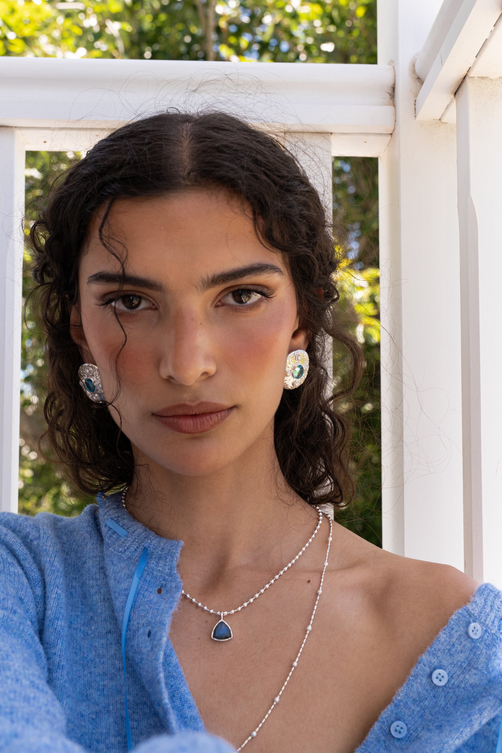 Darcy silver hammered oval stud earrings worn as part of a jewellery stack — Mountain & Moon Chateau Soleil