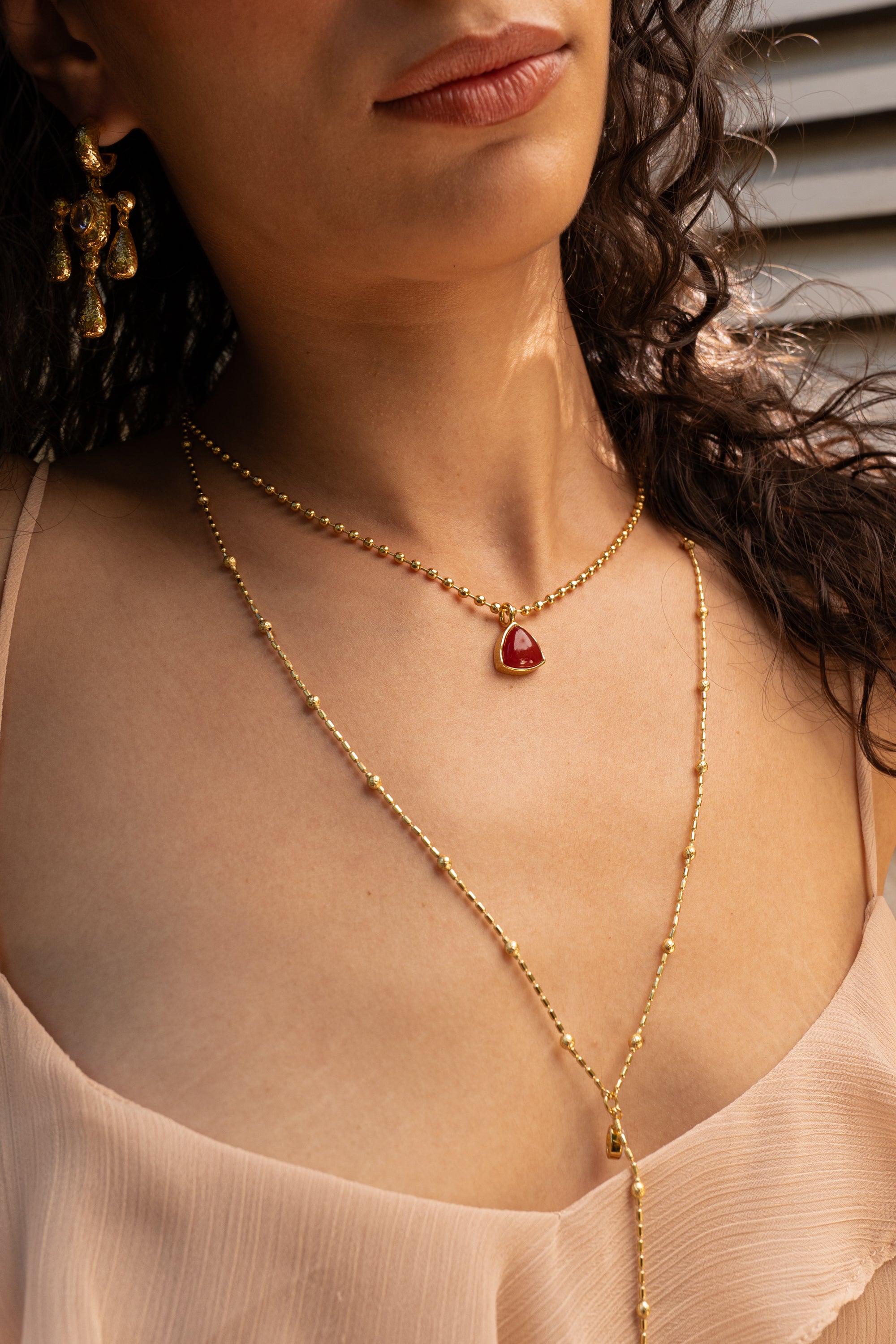 Emery gold pendant necklace with Ruby Quartz worn by model — Mountain & Moon Chateau Soleil collection