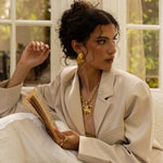 Salma sculptural teardrop stud earrings styled on model in gold — Mountain & Moon jewellery