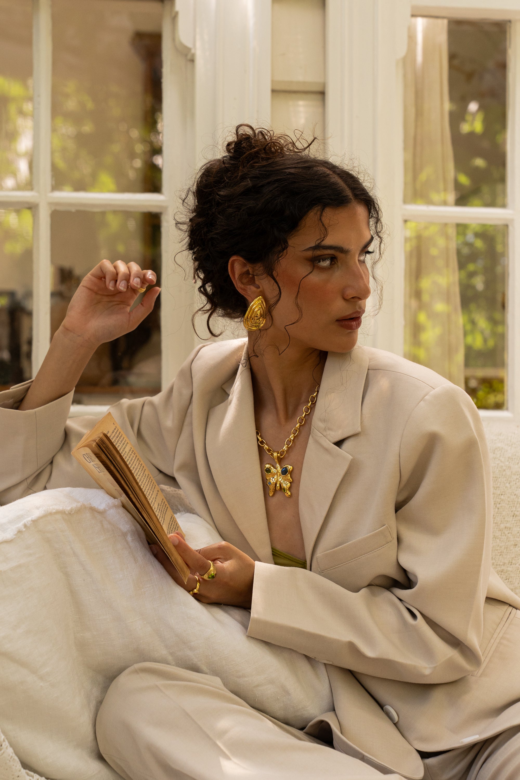 Salma sculptural teardrop stud earrings styled on model in gold — Mountain & Moon jewellery