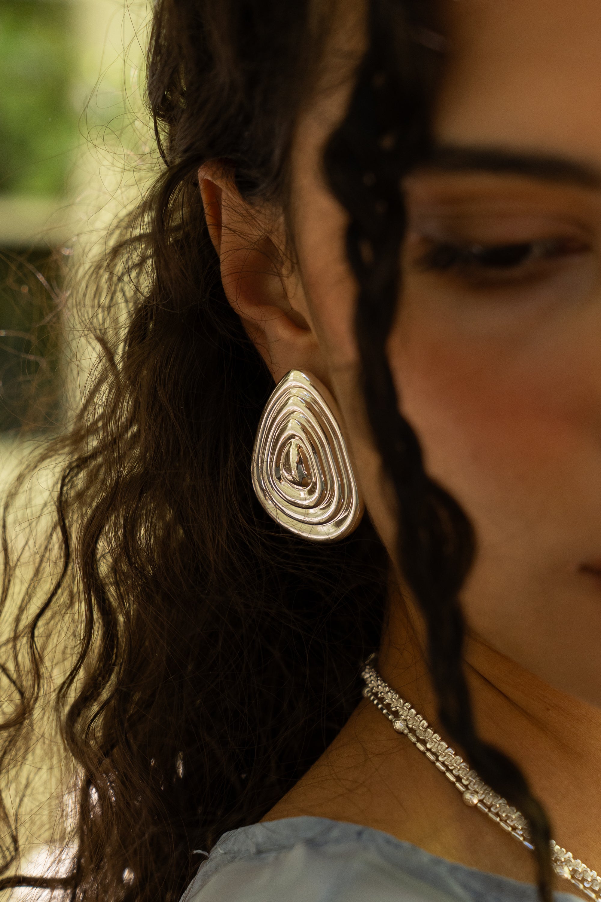 Salma silver sculptural teardrop stud earrings worn by model — Mountain & Moon Chateau Soleil collection