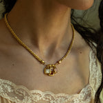 Aura charm necklace styled on model, Ruby Quartz, Mother of Pearl and Pink Chalcedony in gold — Mountain & Moon jewellery