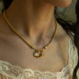Aura charm necklace styled on model, Ruby Quartz, Mother of Pearl and Pink Chalcedony in gold — Mountain & Moon jewellery