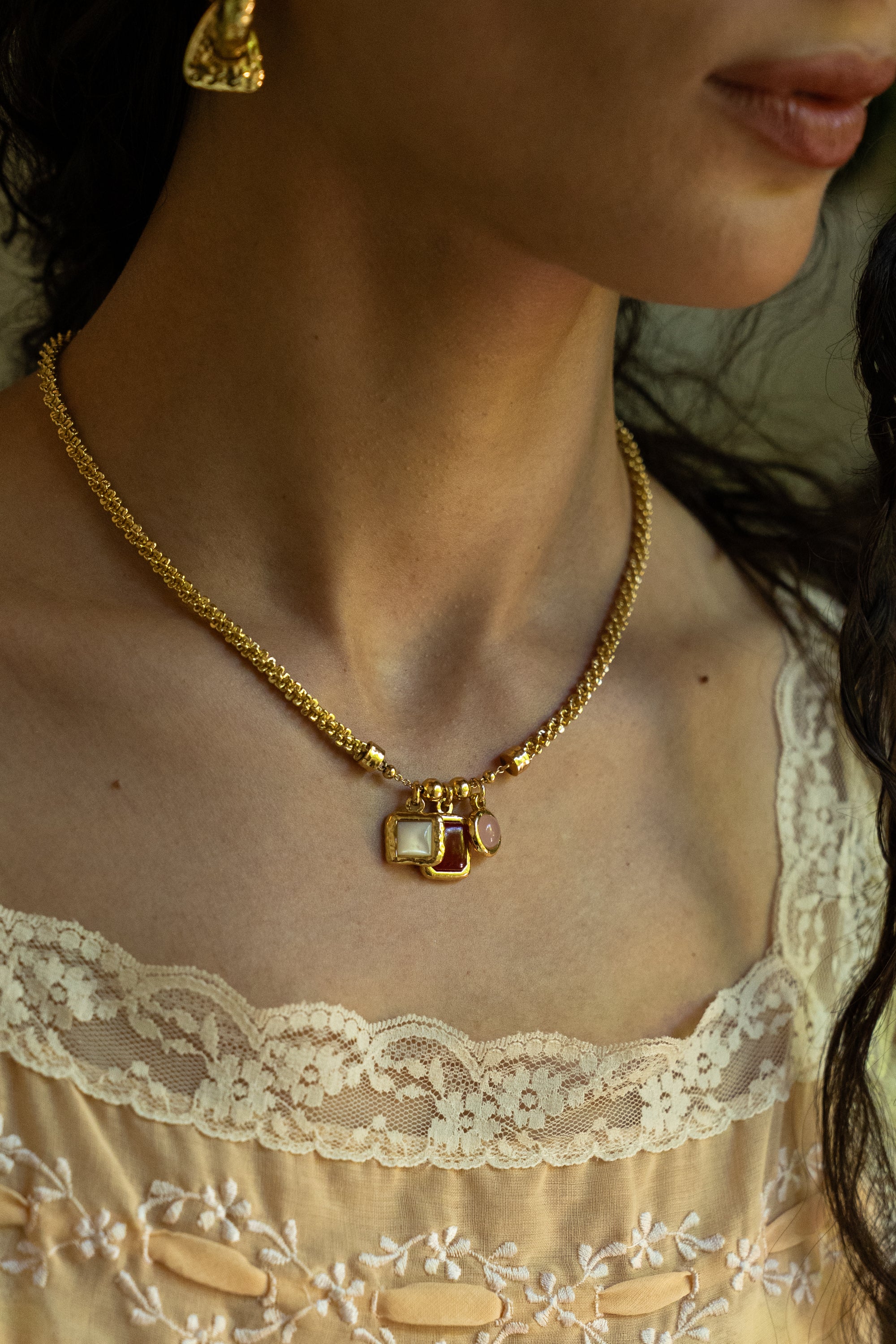 Aura charm necklace styled on model, Ruby Quartz, Mother of Pearl and Pink Chalcedony in gold — Mountain & Moon jewellery
