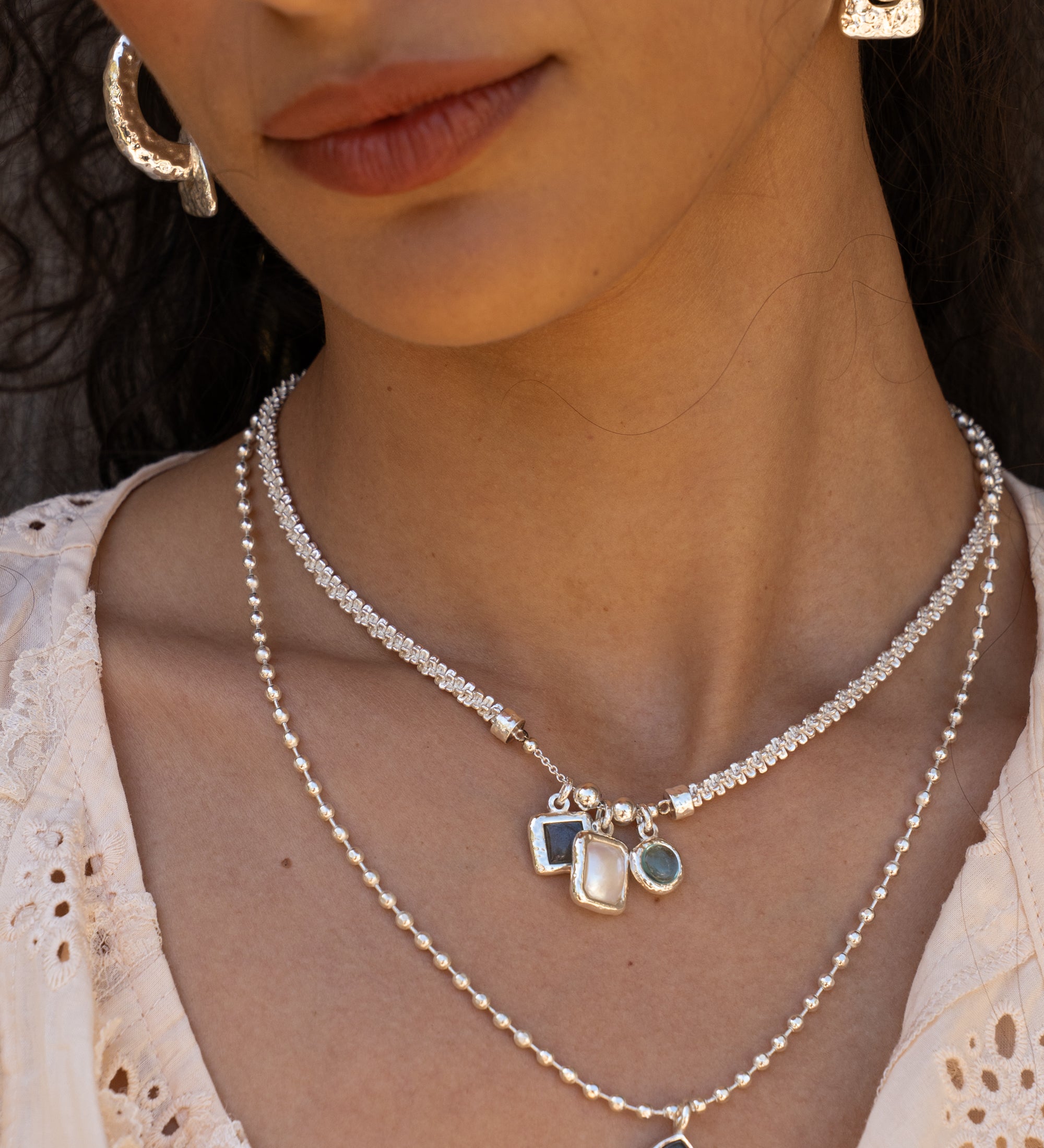 Aura silver charm necklace with Glass Sky Blue Topaz, Labradorite and Freshwater Pearl worn by model — Mountain & Moon Chateau Soleil collection