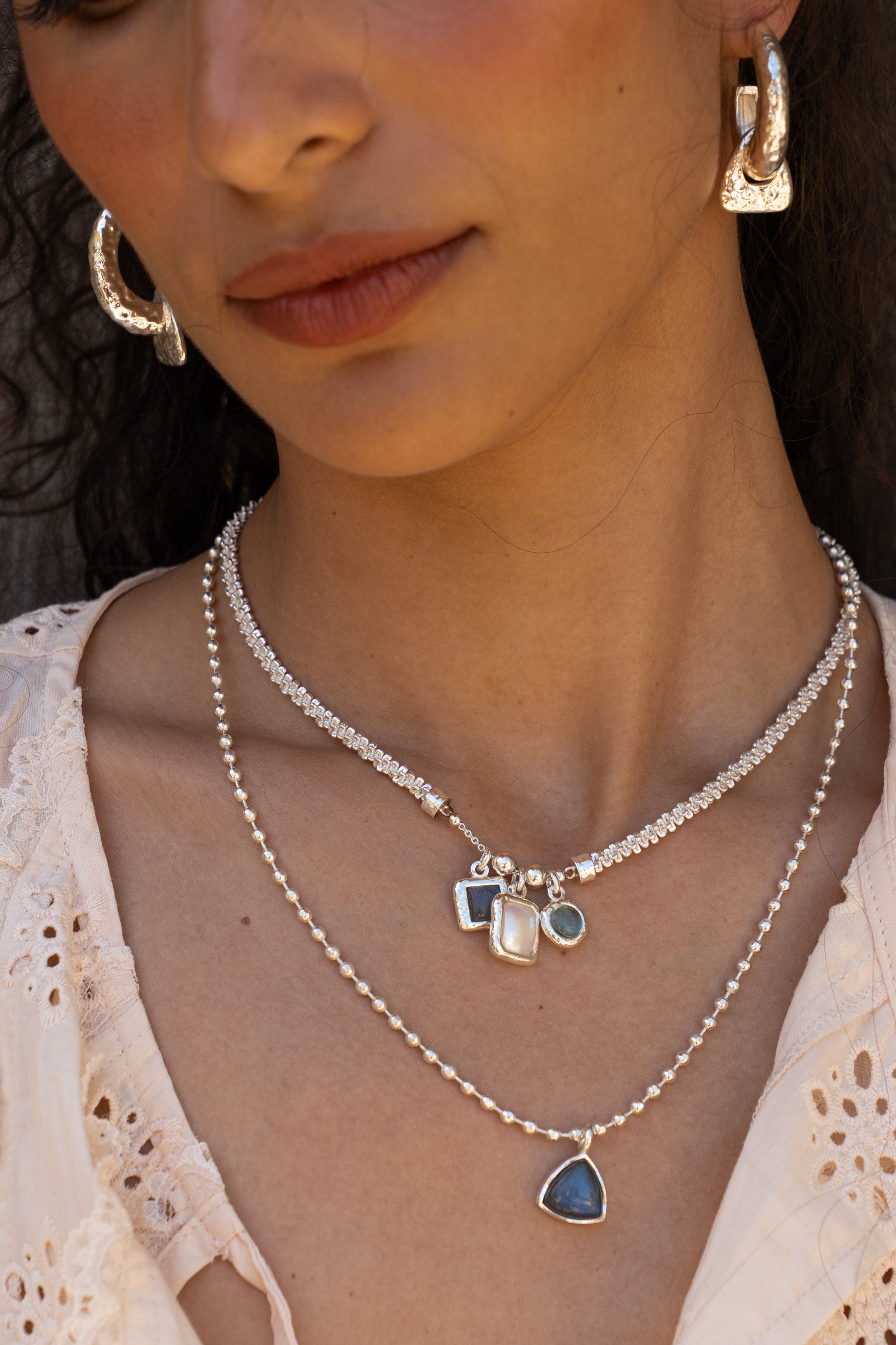 Aura silver charm necklace with Glass Sky Blue Topaz, Labradorite and Freshwater Pearl worn by model — Mountain & Moon Chateau Soleil collection