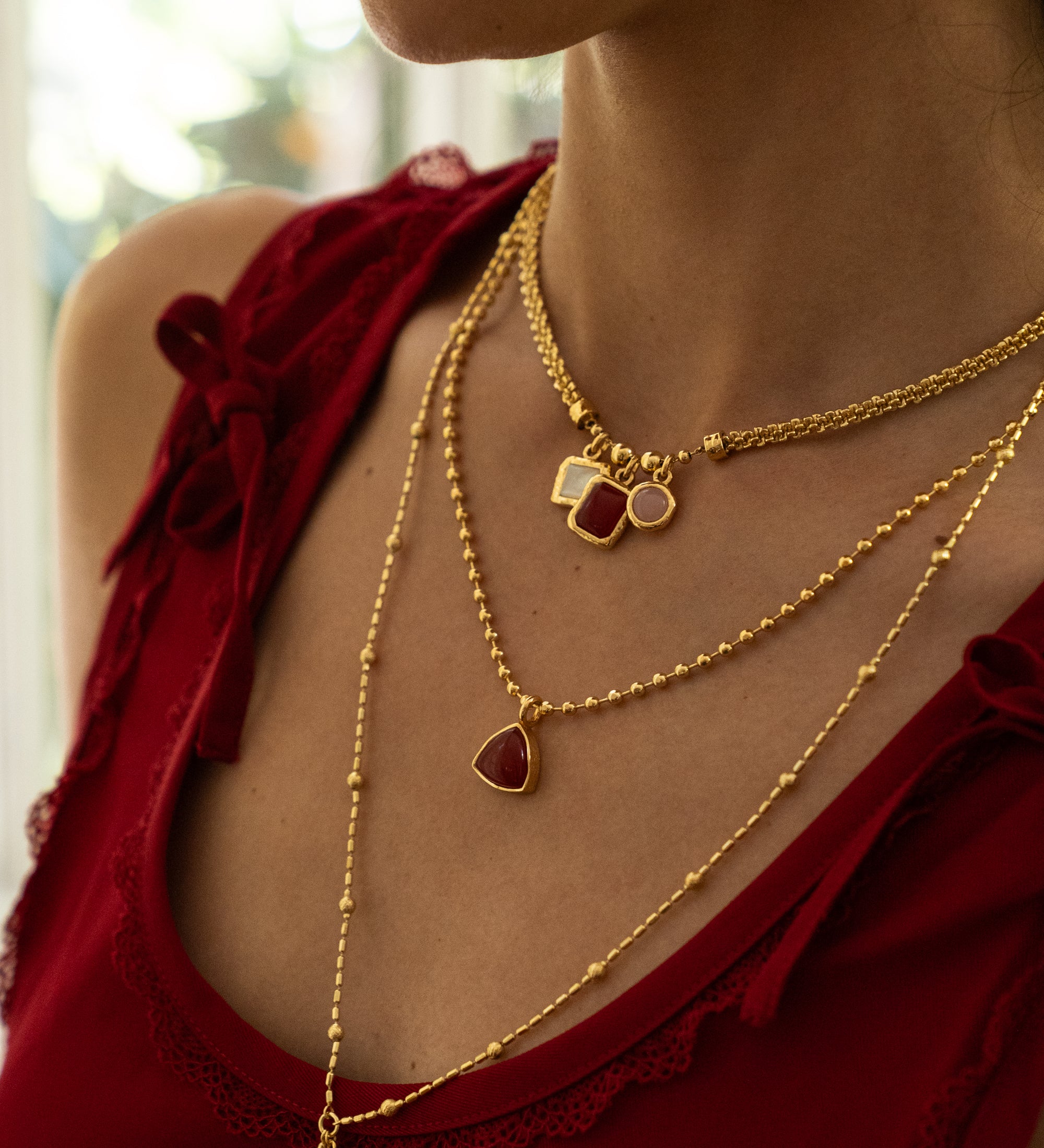 Aura gold charm necklace with Ruby Quartz, Mother of Pearl and Pink Chalcedony worn by model — Mountain & Moon Chateau Soleil collection