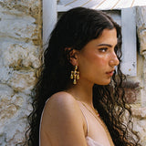 Fleur gold chandelier drop earrings worn as part of a jewellery stack — Mountain & Moon Chateau Soleil