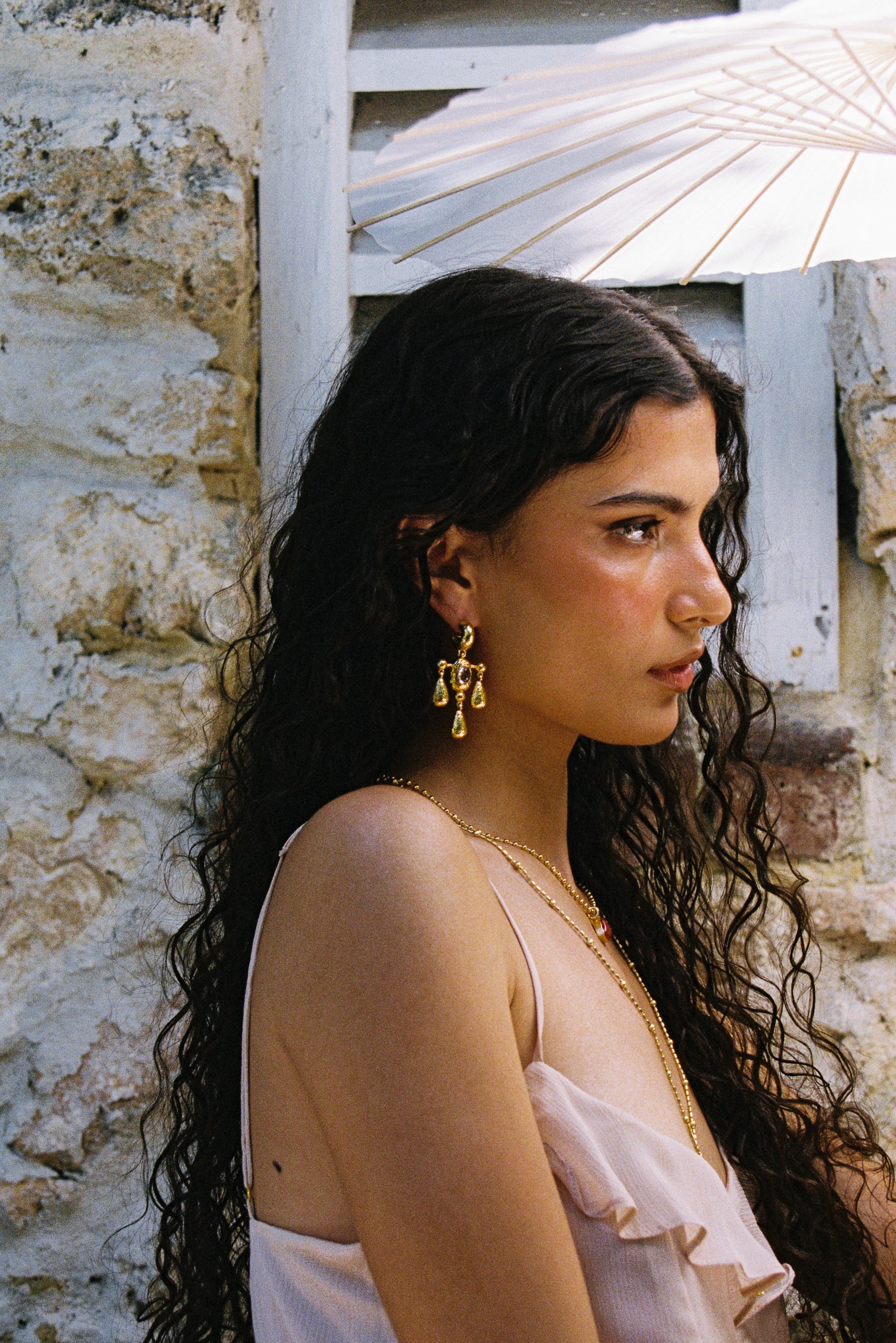 Fleur gold chandelier drop earrings worn as part of a jewellery stack — Mountain & Moon Chateau Soleil