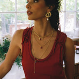 Freya swirled hoop earrings styled on model, Mother of Pearl in gold — Mountain & Moon jewellery