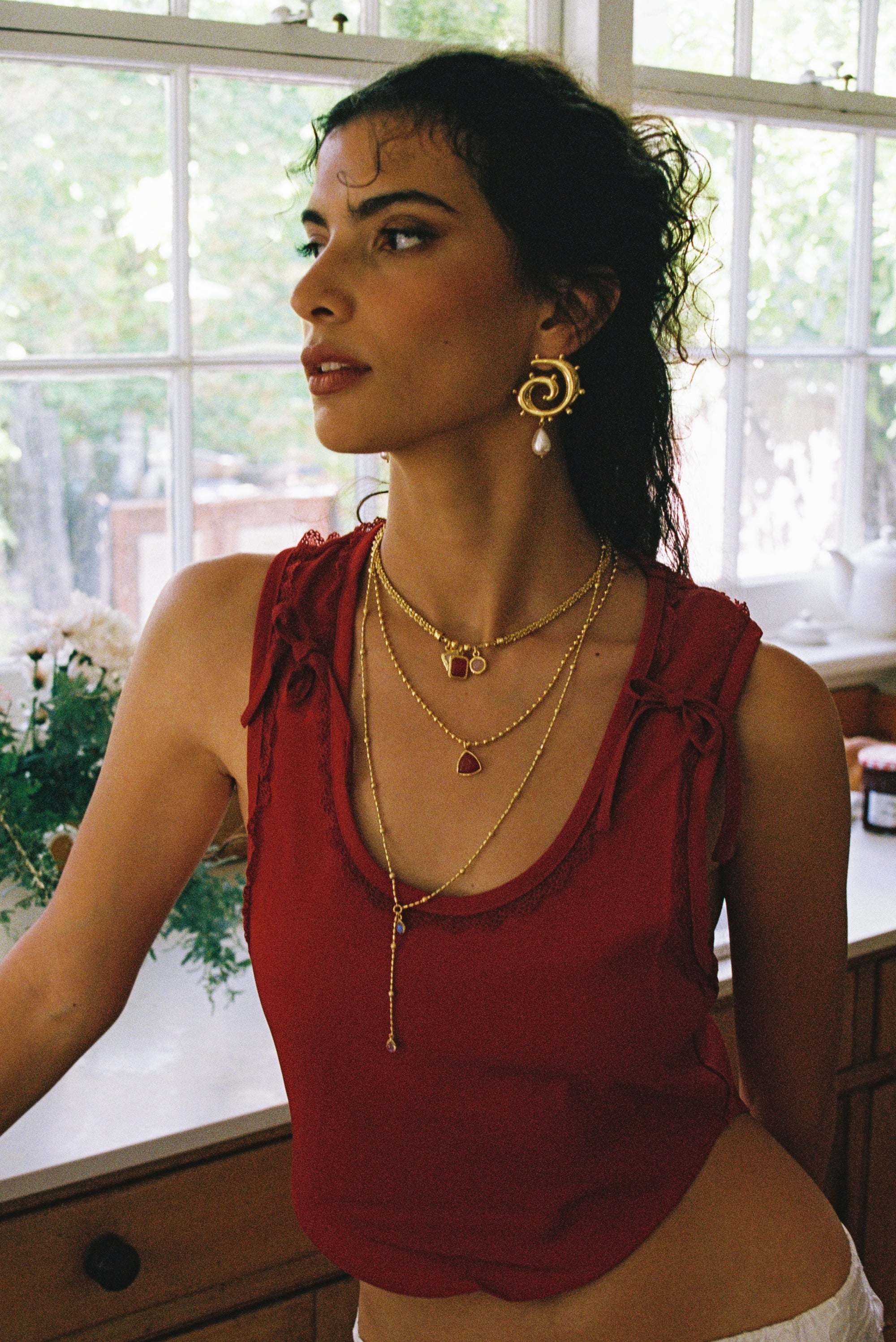 Freya swirled hoop earrings styled on model, Mother of Pearl in gold — Mountain & Moon jewellery