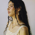 Artemis hammered huggie hoop earrings styled on model, Tigers Eye in gold — Mountain & Moon jewellery