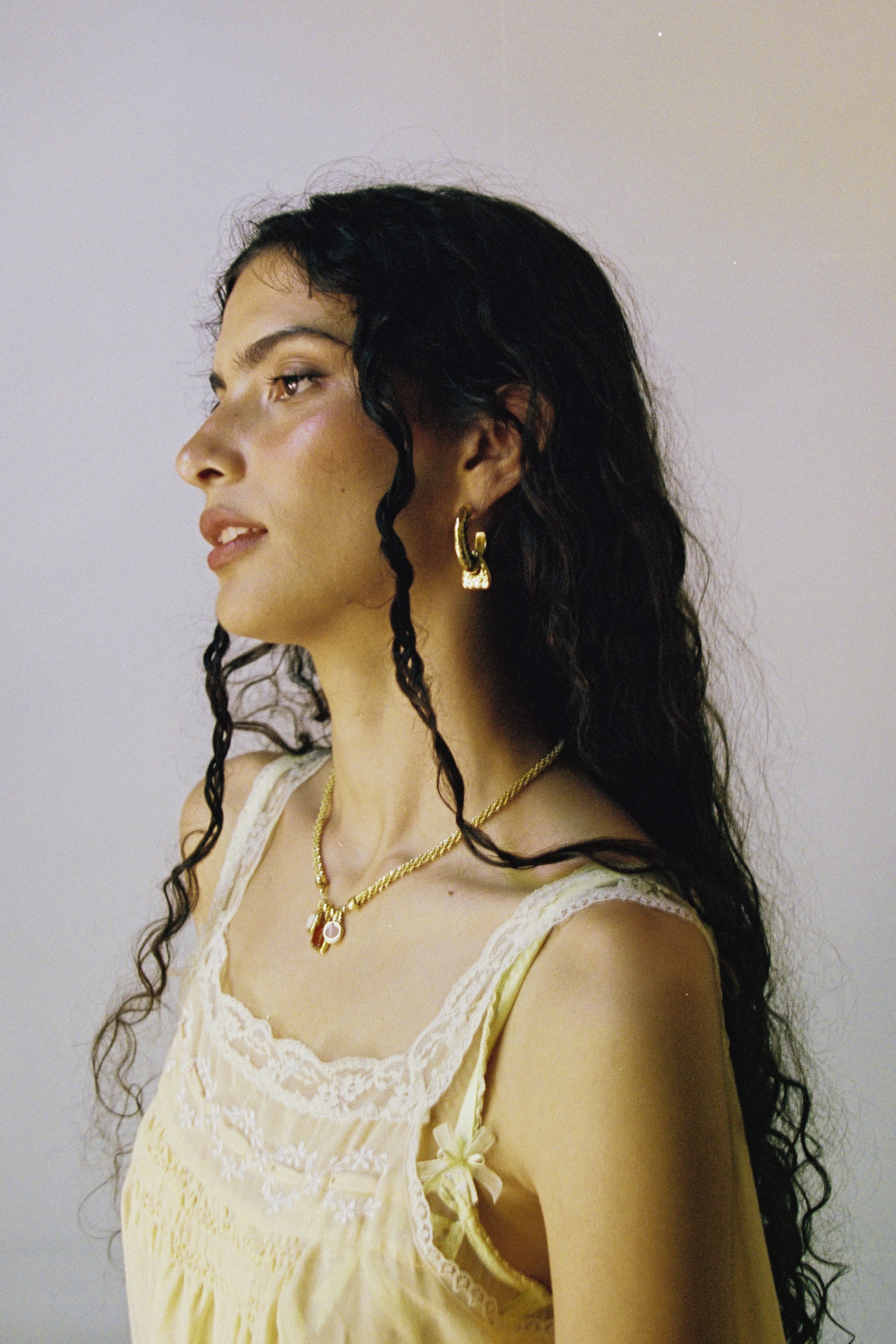 Artemis hammered huggie hoop earrings styled on model, Tigers Eye in gold — Mountain & Moon jewellery