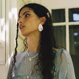 Salma sculptural teardrop stud earrings styled on model in silver — Mountain & Moon jewellery