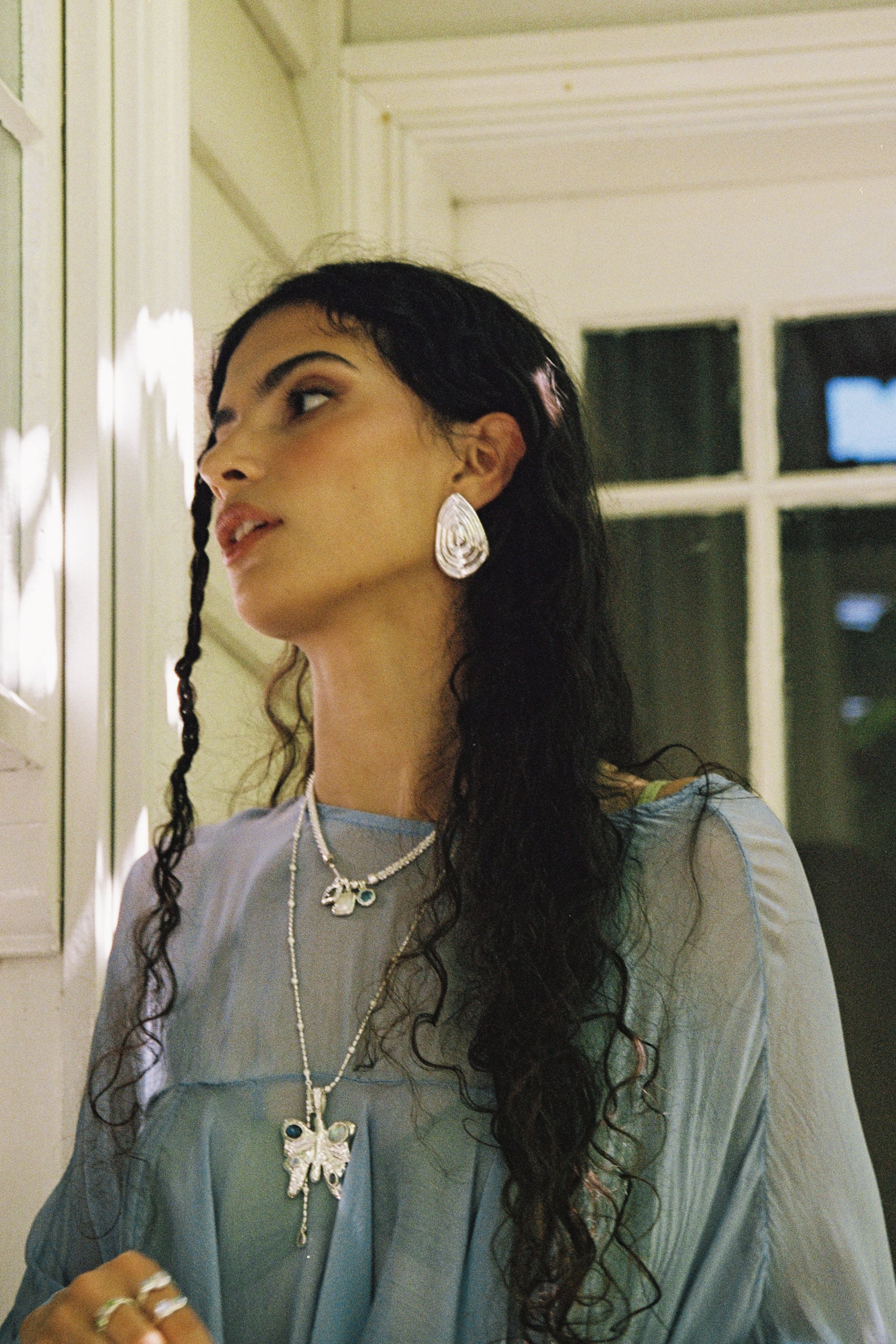 Salma sculptural teardrop stud earrings styled on model in silver — Mountain & Moon jewellery